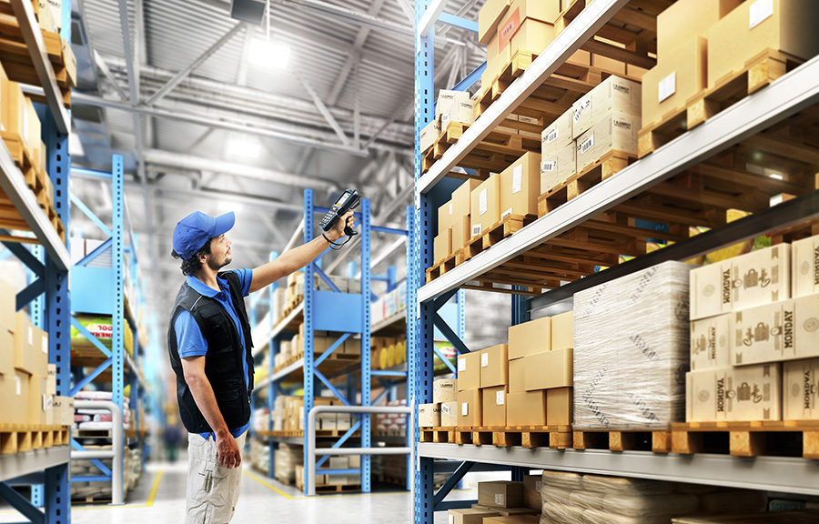 Operator with RFID handheld reader in warehouse